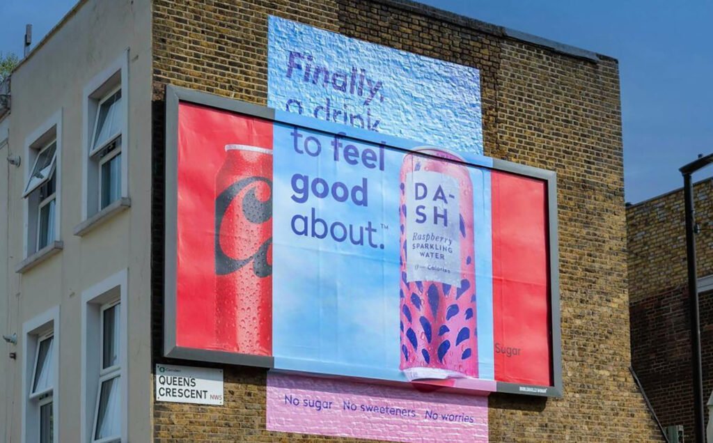 DASH drinks company billboard plastered over the top of a Coca Cola billboard.