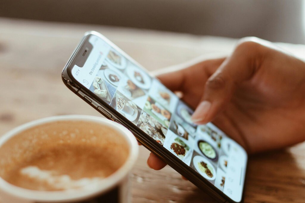 Instagram feed on phone with pictures of food displayed.
