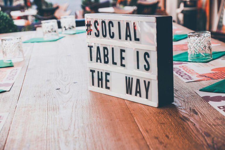 glow sign with '#Social table is this way'