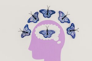 a drawing of the outline of a head with butterflies around it